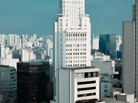 a tall white building in a city
